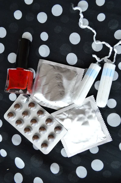 Women tampons, condoms, pills and varnish — Stock Photo, Image