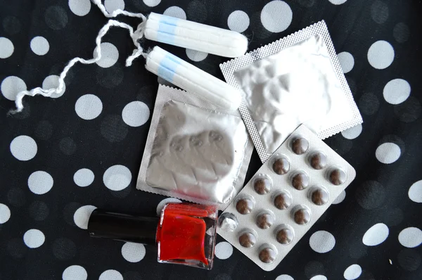 Women tampons, condoms, pills and varnish — Stock Photo, Image