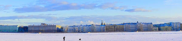 The Neva river in ice. Embankment of St. Petersburg with colorful neat buildings. Museums and architecture of St. Petersburg, Russia. Spring 2017.