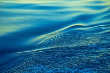The sea level moves smoothly to create layers of ripples. Nature is peaceful and serene, the deep blue North Pacific Ocean. Taken on a cruise ship.