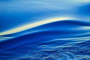 The sea level moves smoothly to create layers of ripples. Nature is peaceful and serene, the deep blue North Pacific Ocean. Taken on a cruise ship.