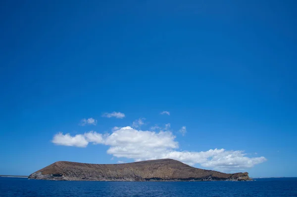 One of the small islands in the Hawaiian Islands. The view from the cruise ship. June 2019.