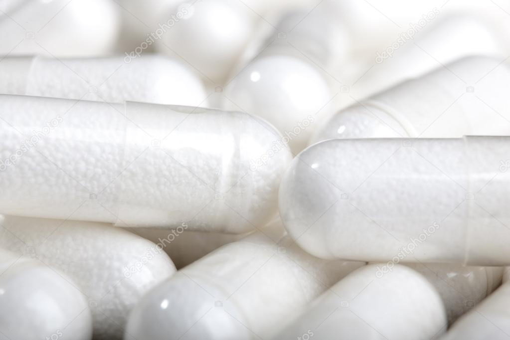 white pills group capsule