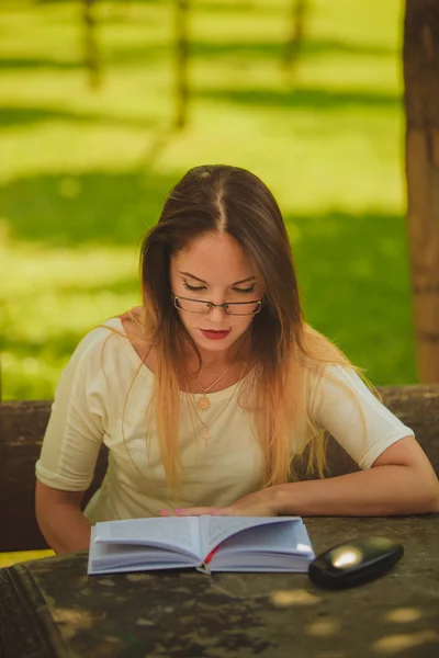 Mädchen mit Buchlesung im Park — Stockfoto