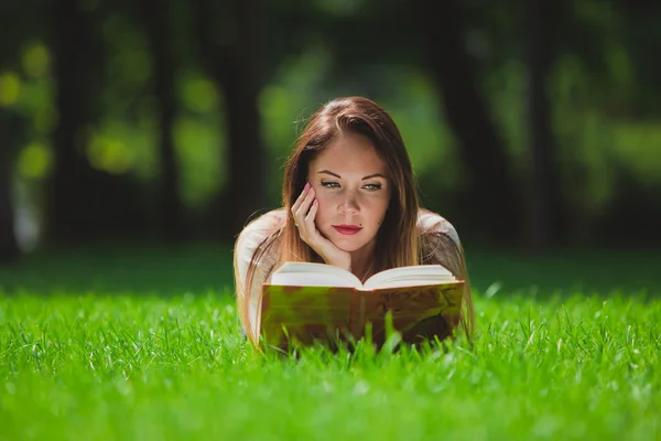 Mädchen mit Buch auf dem Gras — Stockfoto