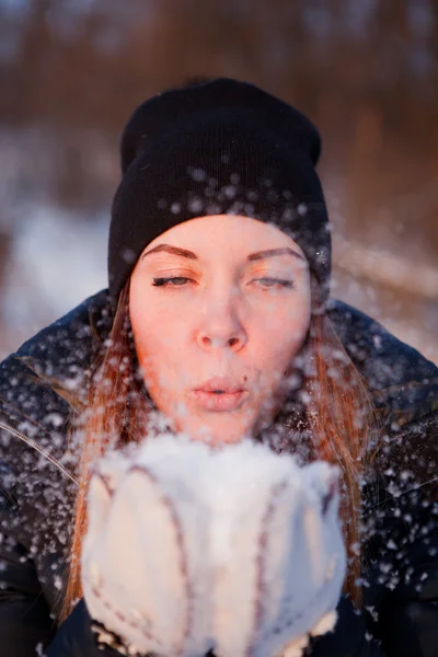 Girl blowing on snow — Stock Photo, Image