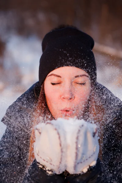 Girl blowing on snow Stock Image