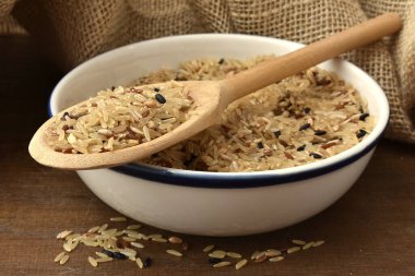 bowl of rice and wooden spoons on table