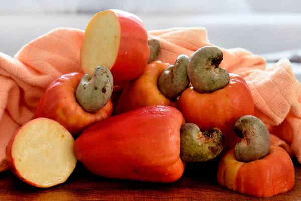 Some cashew fruit on a wooden table