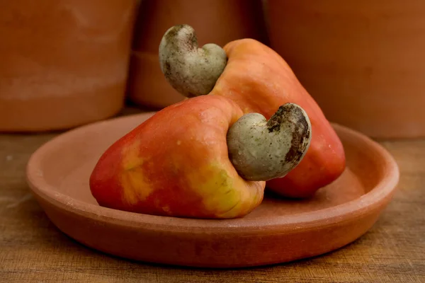 Some cashew fruit on a wooden table