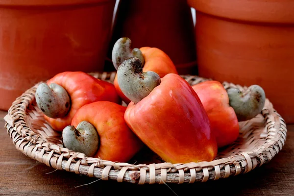 Some cashew fruit on a wooden table