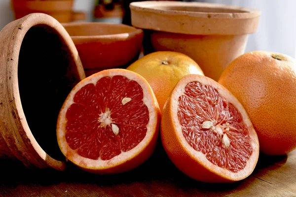 fresh ripe red grapefruits on wooden background