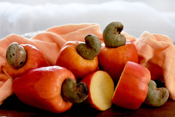 Some cashew fruit on a wooden table