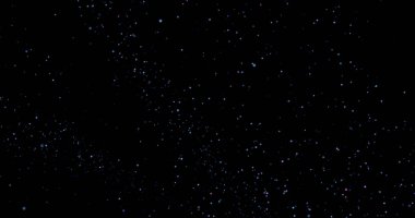 Siyah arkaplanda uçan toz parçacıkları