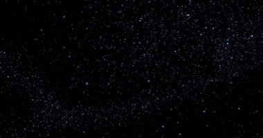 Siyah arkaplanda uçan toz parçacıkları