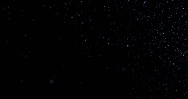 Siyah arkaplanda uçan toz parçacıkları