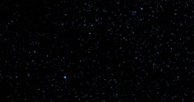 Siyah arkaplanda uçan toz parçacıkları