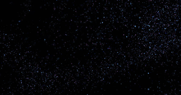 Flying dust particles on a black background