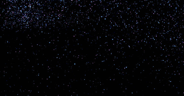 Flying dust particles on a black background