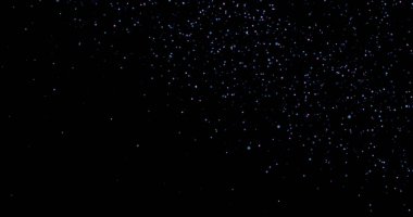 Siyah arkaplanda uçan toz parçacıkları