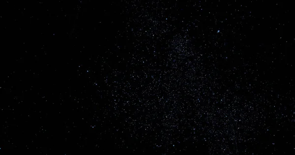 Flying dust particles on a black background