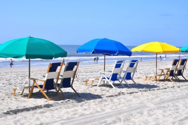 Plajda şemsiye ile plaj sandalyeleri.