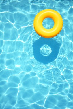 Yellow pool floats in a swimming pool clipart