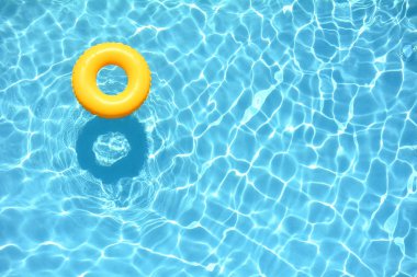 Yellow pool floats in a swimming pool clipart