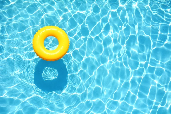 Yellow pool floats in a swimming pool — Stock Photo, Image