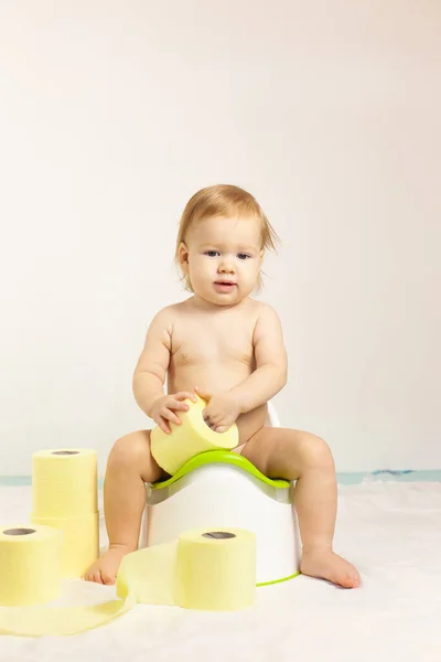 baby sits on a baby potty. Children\'s hygiene. Potty training