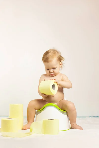 baby sits on a baby potty. Children\'s hygiene. Potty training