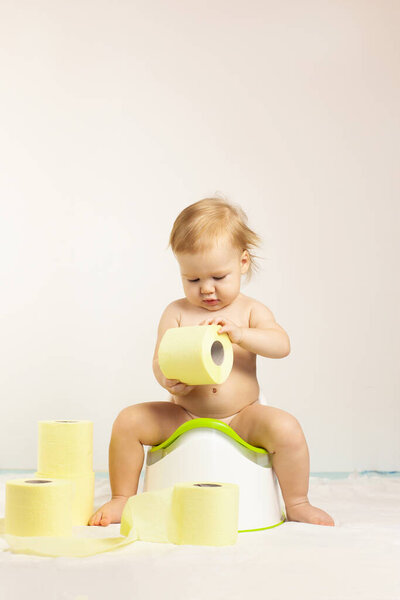 baby sits on a baby potty. Children's hygiene. Potty training