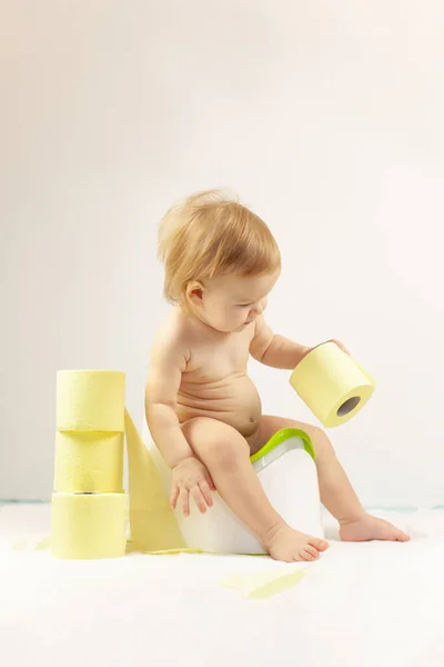 baby sits on a baby potty. Children\'s hygiene. Potty training