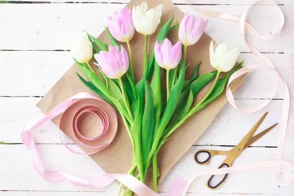 Çiçekçi bir buket yumuşak lale topluyor, seçici bir odak noktası var. Kadınlar Günü, Sevgililer Günü. Anneler Günü