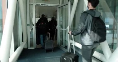 Arnavutkoy, İstanbul, Türkiye - 03.08.2021: bavullu bazı erkek yolcular İstanbul Havalimanı 'nda uçağa binmek üzere yürüyorlar
