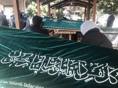 Sisli, İstanbul, Türkiye - 04.20.2021: Zincirlikuyu Mezarlığı 'na gömülmek için sırada bekleyen çok sayıda tahta Türk tabutu ve İslam metni (çeviri: her ruh ölümü tadacak. Sonra bize döndürüleceksiniz.)