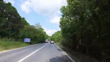 Sariyer, İstanbul, Türkiye - 06.14.2021: Belgrad Orman yolunda bir çok araba yeşil ağaçların yanından geçerek yaz günlerinde mavi gökyüzü altında tatile çıkıyor.