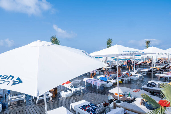 Sariyer, Istanbul, Turkey - 07.17.2021: luxury Burc beach club place in Kilyos and coastal area with a lot of people laying down on sunloungers under straw umbrellas in summer for sunbathing