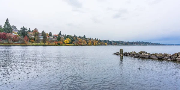 Homes face Lake Washington in Seattle. It is autumn.