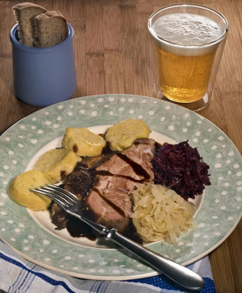 Roasted pork with sauerkraut and potato dumplings — Stock Photo, Image