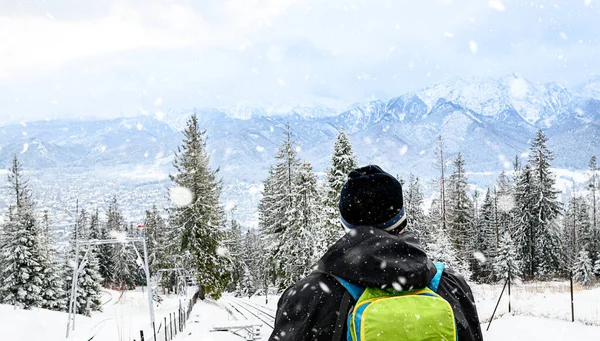 View From the back. A lonely standing man high in the mountains looks at the mountains. Zakopane, Gubalowka. High quality photo