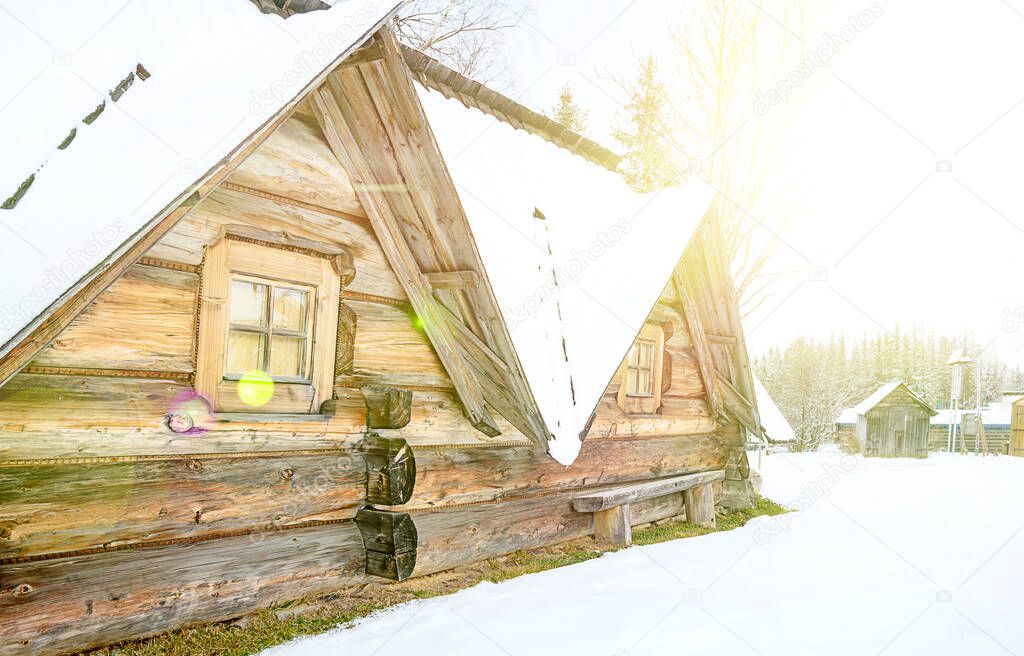 old traditional mountain farmhouse, scenic winter wonderland scenery, sunlight. High quality photo