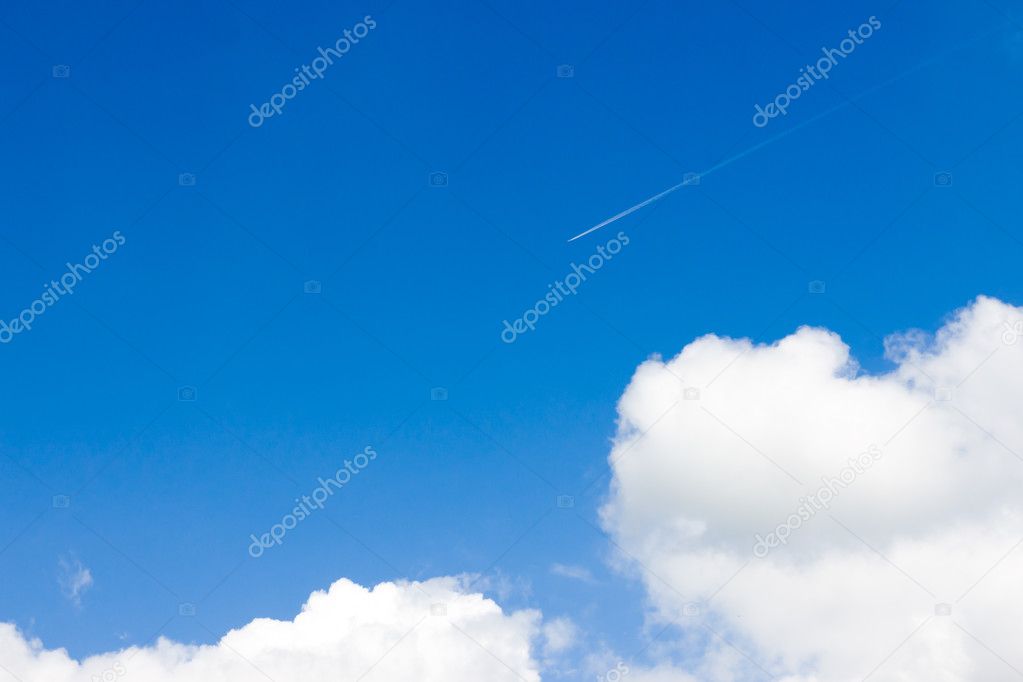 trail of an airplane in the blue sky