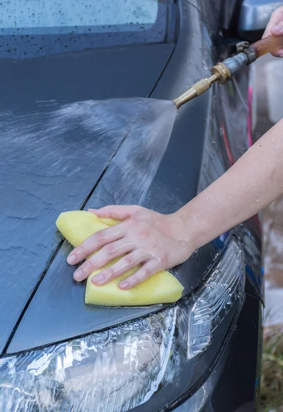 スポンジ石鹸洗濯赤い車表面を持つ人間の手 — ストック写真