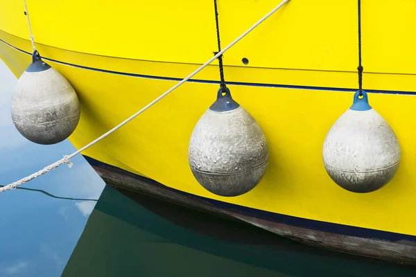 Yellow boat, buoys, and seawater — Stock Photo, Image