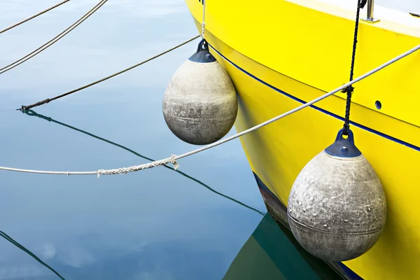 Yellow boat, buoys, and seawater — Stock Photo, Image