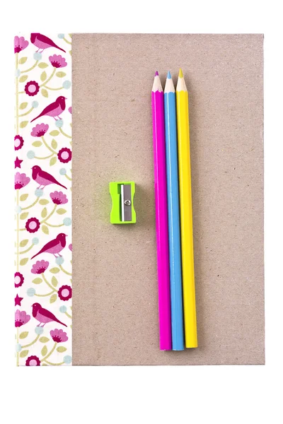 Notebook, color pencils and pencil sharpener — Stock Photo, Image