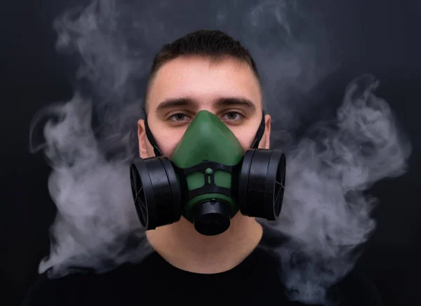 closeup men wearing respirator mask industrial cartridge filter anti-dust safety chemical with soft-focus and over light in the background