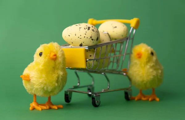 Creative for Easter. Chickens toy with yellow Easter eggs in a basket.