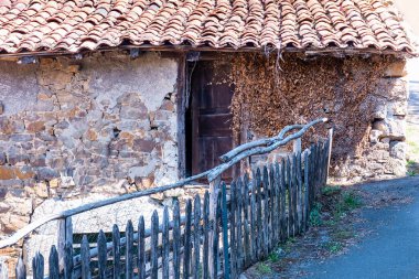 View of an apparently abandoned old house in a village in Asturias, Spain.Photograph with a predominantly brownish tone and shot in horizontal format.